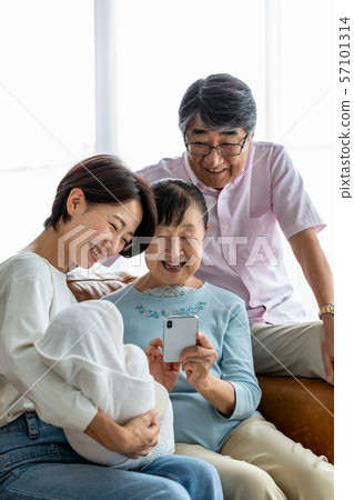 Senior couple taking picture of grandchild (vertical position) Senior couple taking picture of grandchild (vertical position) 57101314