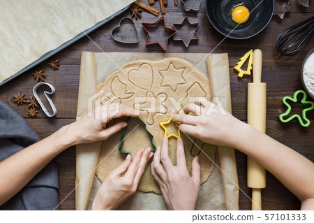 Mom with child prepare Christmas cookies. 57101333