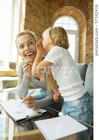 Teacher and little girl, or mom and daughter. Homeschooling concept 57102416