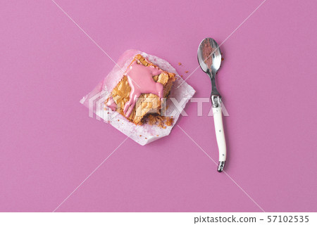 Eating a brownie cake with pink chocolate Eating a brownie cake with pink chocolate 57102535