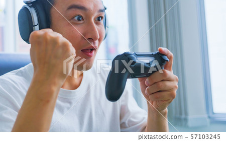 Image of e-sports: Scenes where young people are excited to play games with a controller in one hand 57103245
