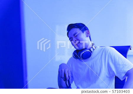 Image of e-sports: Scenes where young people are excited to play games with a controller in one hand Image of e-sports: Scenes where young people are excited to play games with a controller in one hand 57103403