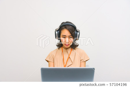 Image of operator work: Image of female staff performing remote control using a controller in the work room 57104196