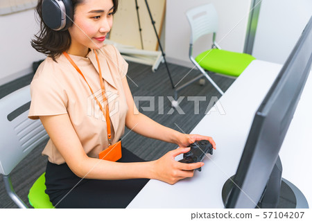 Image of operator work: Image of female staff performing remote control using a controller in the work room Image of operator work: Image of female staff performing remote control using a controller in the work room 57104207