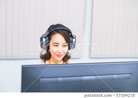 Image of operator work: Image of female staff performing remote control using a controller in the work room Image of operator work: Image of female staff performing remote control using a controller in the work room 57104210