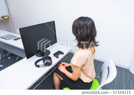 Image of operator work: Image of female staff performing remote control using a controller in the work room Image of operator work: Image of female staff performing remote control using a controller in the work room 57104215