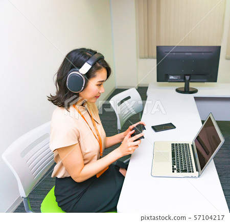 Image of operator work: Image of female staff performing remote control using a controller in the work room 57104217