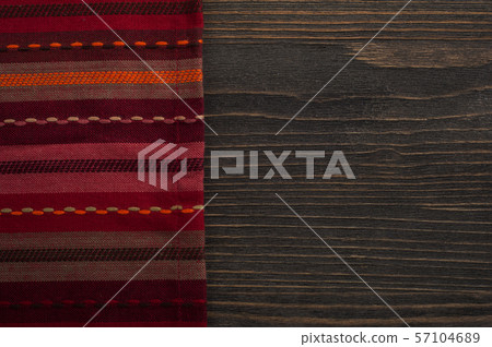 Dark wooden background with red napkin 57104689
