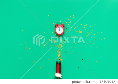 Red alarm clock on green background with golden glitter stars. 2020 new year or chritmas eve card Red alarm clock on green background with golden glitter stars. 2020 new year or chritmas eve card 57105942