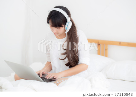 Beautiful young asia woman lying in bedroom using laptop computer showing video call chat Beautiful young asia woman lying in bedroom using laptop computer showing video call chat 57110848