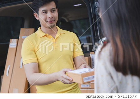 Young Asian Delivery man delivering packages Young Asian Delivery man delivering packages 57111577
