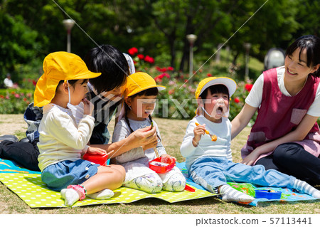 Children eating lunch in the park Children eating lunch in the park 57113441