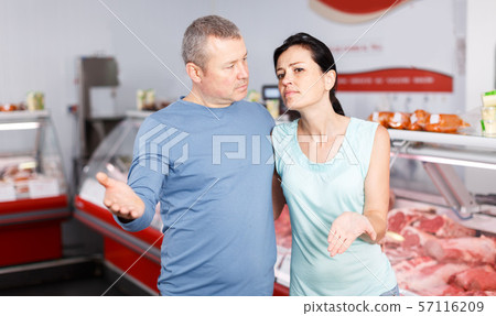 Adult couple customers posing in shop 57116209