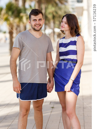 Happy man and girl standing and hugging Happy man and girl standing and hugging 57116239
