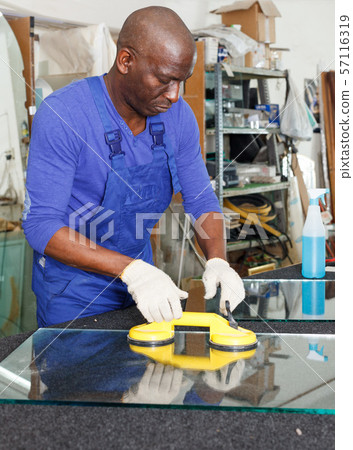 Man working in glass workshop Man working in glass workshop 57116319