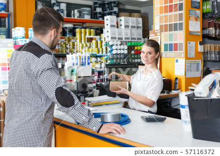 Woman seller standing at the counter and consulting male 57116372