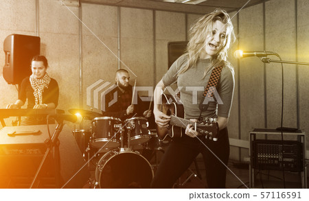 excited girl rock singer with guitar during rehearsal 57116591