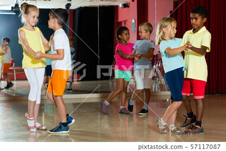 Group of ordinary children dancing salsa dance Group of ordinary children dancing salsa dance 57117087
