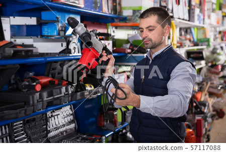 Man choosing drilling machine Man choosing drilling machine 57117088