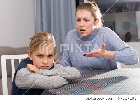 Dissatisfied mother scolds little girl 57117193