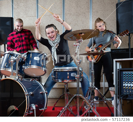 Music band with adult girl drummer rehearsing Music band with adult girl drummer rehearsing 57117236
