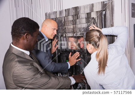 Businesspeople holding door Businesspeople holding door 57117566