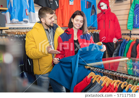 Couple choosing jacket in store 57117583