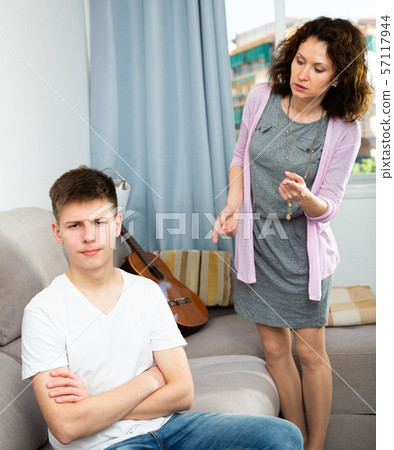 Worried mother talking to son 57117944