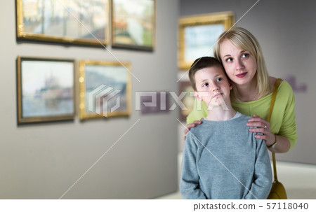 Mother and son looking at paintings in halls of museum Mother and son looking at paintings in halls of museum 57118040