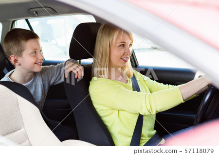 Mother and son using car during sightseeing tour Mother and son using car during sightseeing tour 57118079