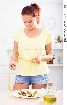 girl with measuring tape 57118301