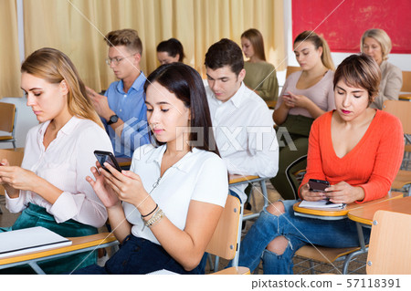 Students using smartphones to find necessary information on lecture in university class 57118391