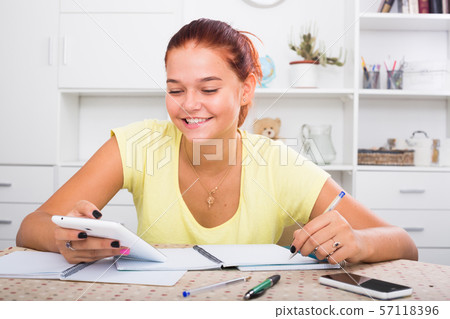 smiling girl writing 57118396