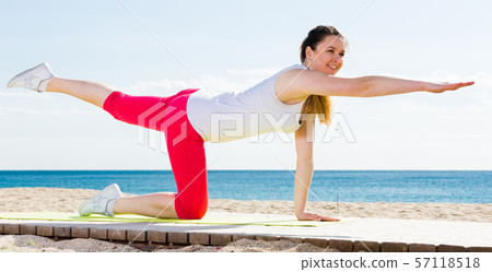 Woman doing yoga sitting Woman doing yoga sitting 57118518