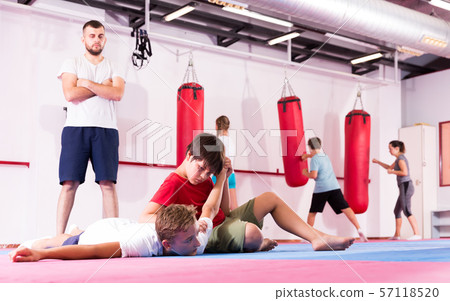 Kids practicing in pair self-protection Kids practicing in pair self-protection 57118520
