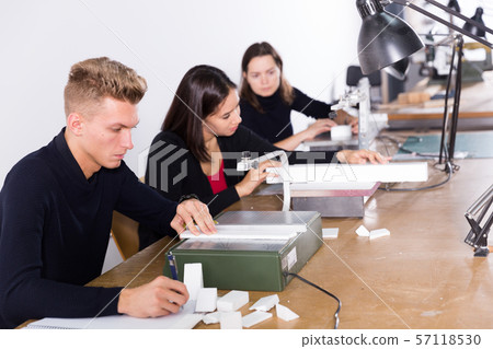 Architect making details for architectural model on fretsaw Architect making details for architectural model on fretsaw 57118530