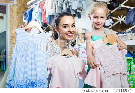 portrait of woman and girl shopping kids apparel in clothes store portrait of woman and girl shopping kids apparel in clothes store 57118954
