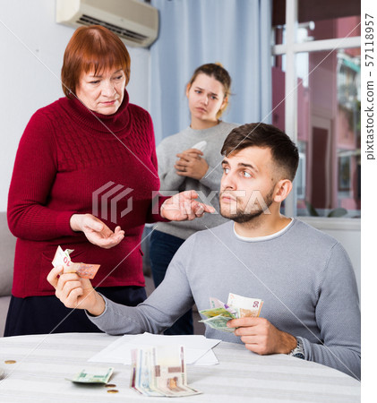 Elderly mother asking adult son for money 57118957