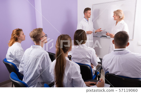 Young guy medical student talking with teacher