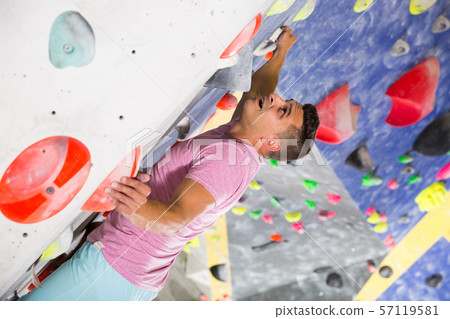 Male on climbing wall without belay Male on climbing wall without belay 57119581