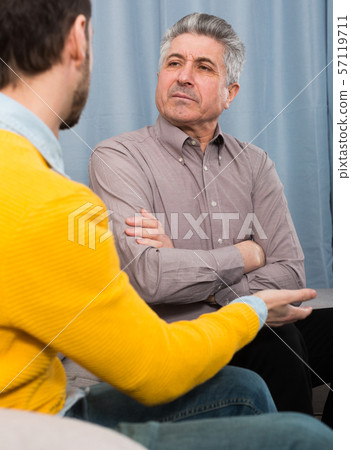 Adult father and son solve problems 57119711