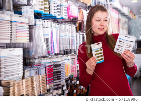 female is choosing decorations for her hair female is choosing decorations for her hair 57119996
