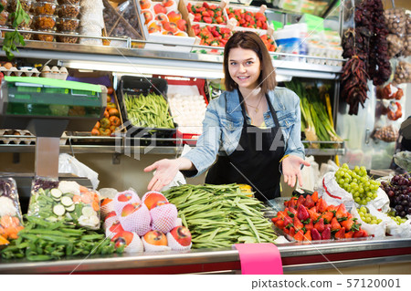 Woman seller displaying assortment Woman seller displaying assortment 57120001