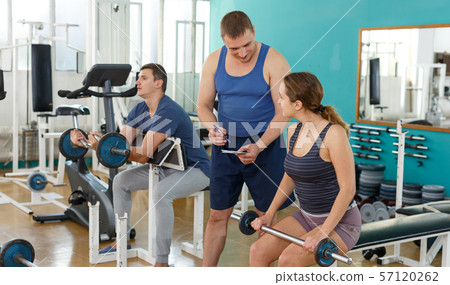 Young woman doing exercises with barbell Young woman doing exercises with barbell 57120262