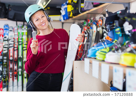 Portrait of young customer woman in ski helmet 57120888