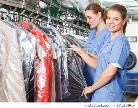 Two modern workers of laundry during daily work Two modern workers of laundry during daily work 57120969