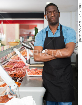 owner of butcher shop standing with arms crossed owner of butcher shop standing with arms crossed 57120980