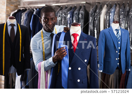 Seller is demonstrating jacket and tie in store 57121024