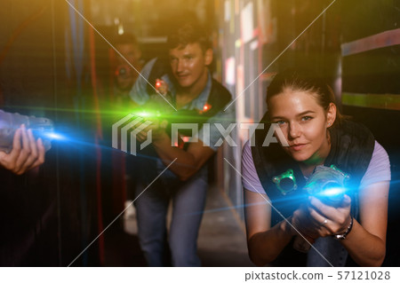 Young female with laser gun took aim and having fun with friend 57121028