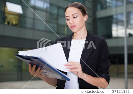 Female creative director is examining documents Female creative director is examining documents 57121551